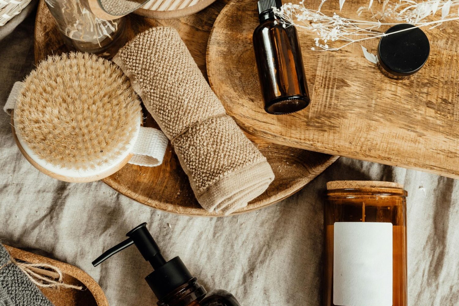 Aesthetic arrangement of natural skincare products and accessories on a wooden tray.